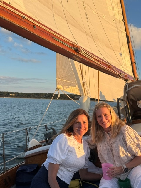two women smiling on boat