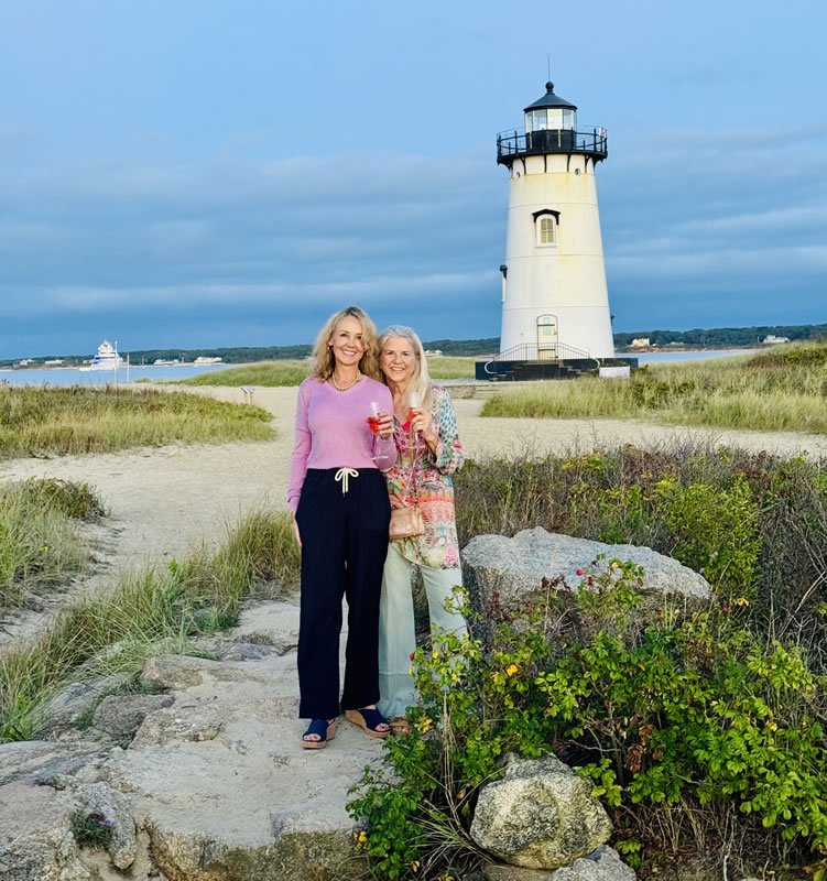 Two women in front of lighthouse