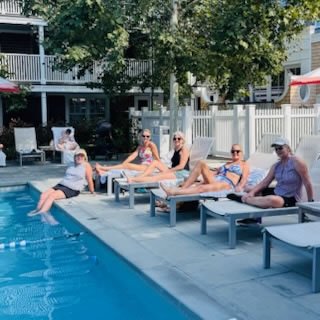 women sitting by the pool